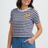Woman wearing a striped shirt with a small yellow graphic on a plain background