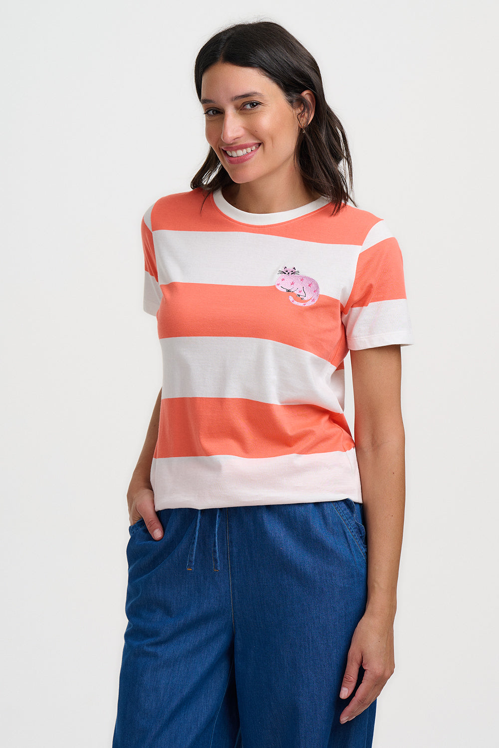 Woman wearing a striped shirt and blue pants on a white background