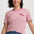 Woman wearing a pink and green striped t-shirt with a logo on a white background