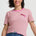 Woman wearing a pink and green striped t-shirt with a logo on a white background