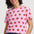 Woman wearing a pink t-shirt with strawberry pattern on a white background