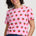 Woman wearing a pink t-shirt with strawberry pattern on a white background