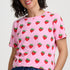 Woman wearing a pink t-shirt with strawberry pattern on a white background