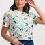 Woman wearing a colorful t-shirt with animal and floral pattern on a white background