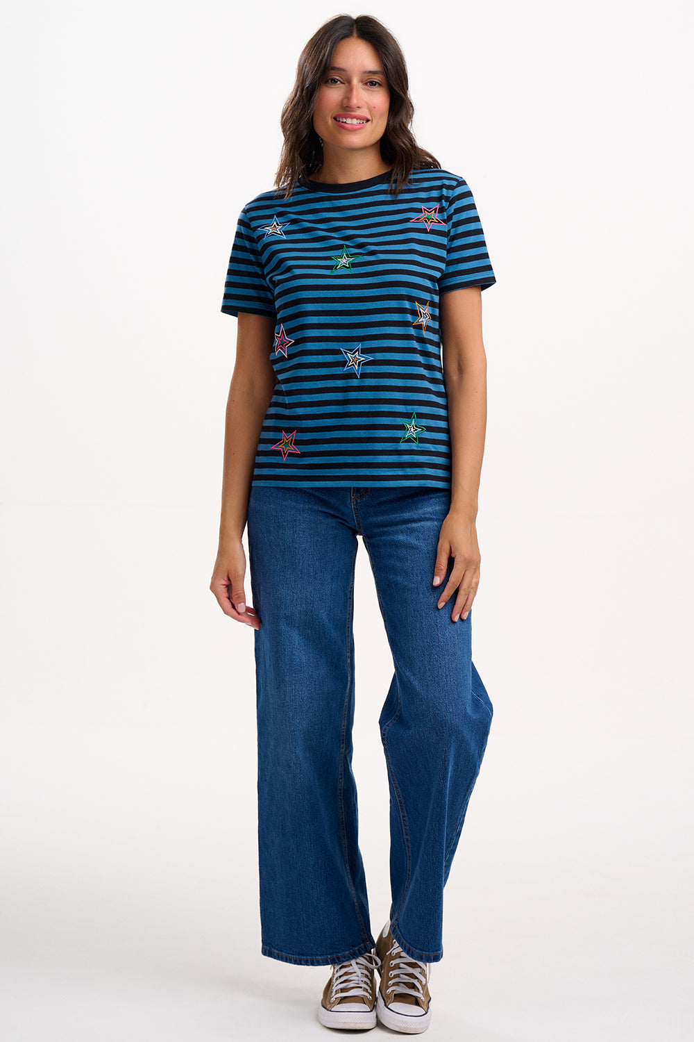 Woman wearing a blue striped t-shirt and jeans on a white background