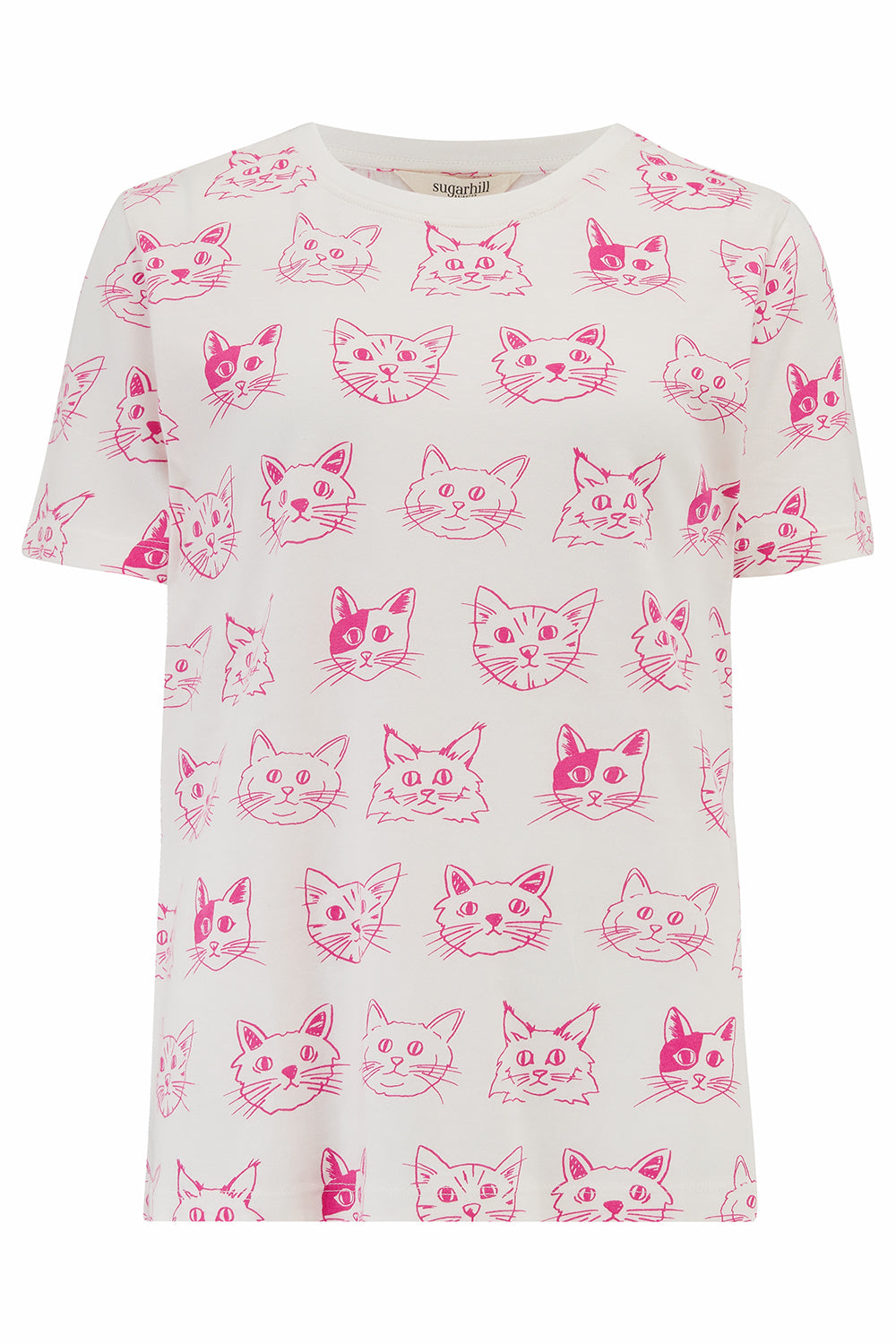 Woman wearing a white t-shirt with pink cat patterns.
