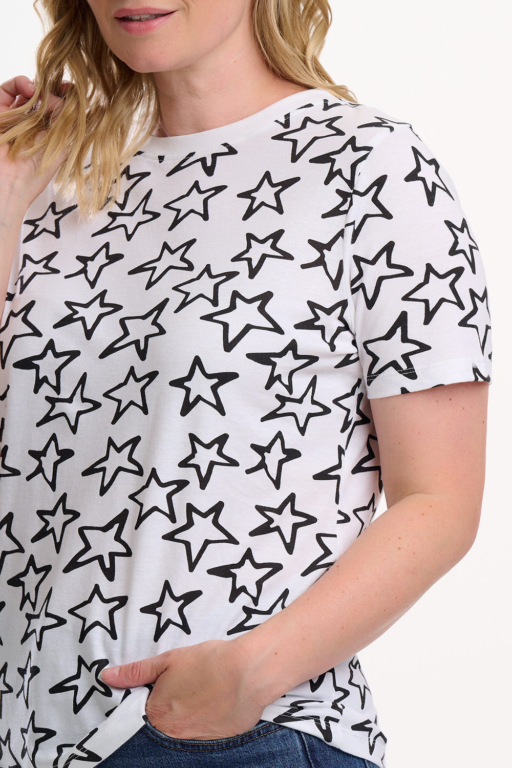 Person wearing a white t-shirt with black star patterns