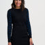 Woman wearing a black dress with blue patterned sleeves on a white background