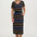 Woman wearing a black dress with colorful stripes on a white background