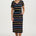 Woman wearing a black dress with colorful stripes on a white background