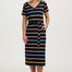 Woman wearing a black dress with colorful stripes on a white background