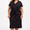 A model wearing a midi-length jersey dress with a V-neck, tie belt, and undulating multicoloured wave print. The dress is primarily black with red, pink, green, blue, and orange patterns.