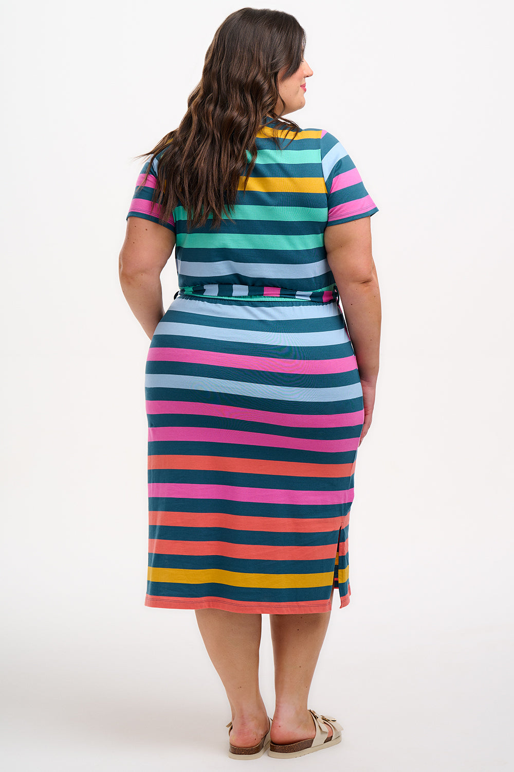 A model wearing a midi-length V-neck dress with stripes in green and other colors, featuring a matching tie belt.
