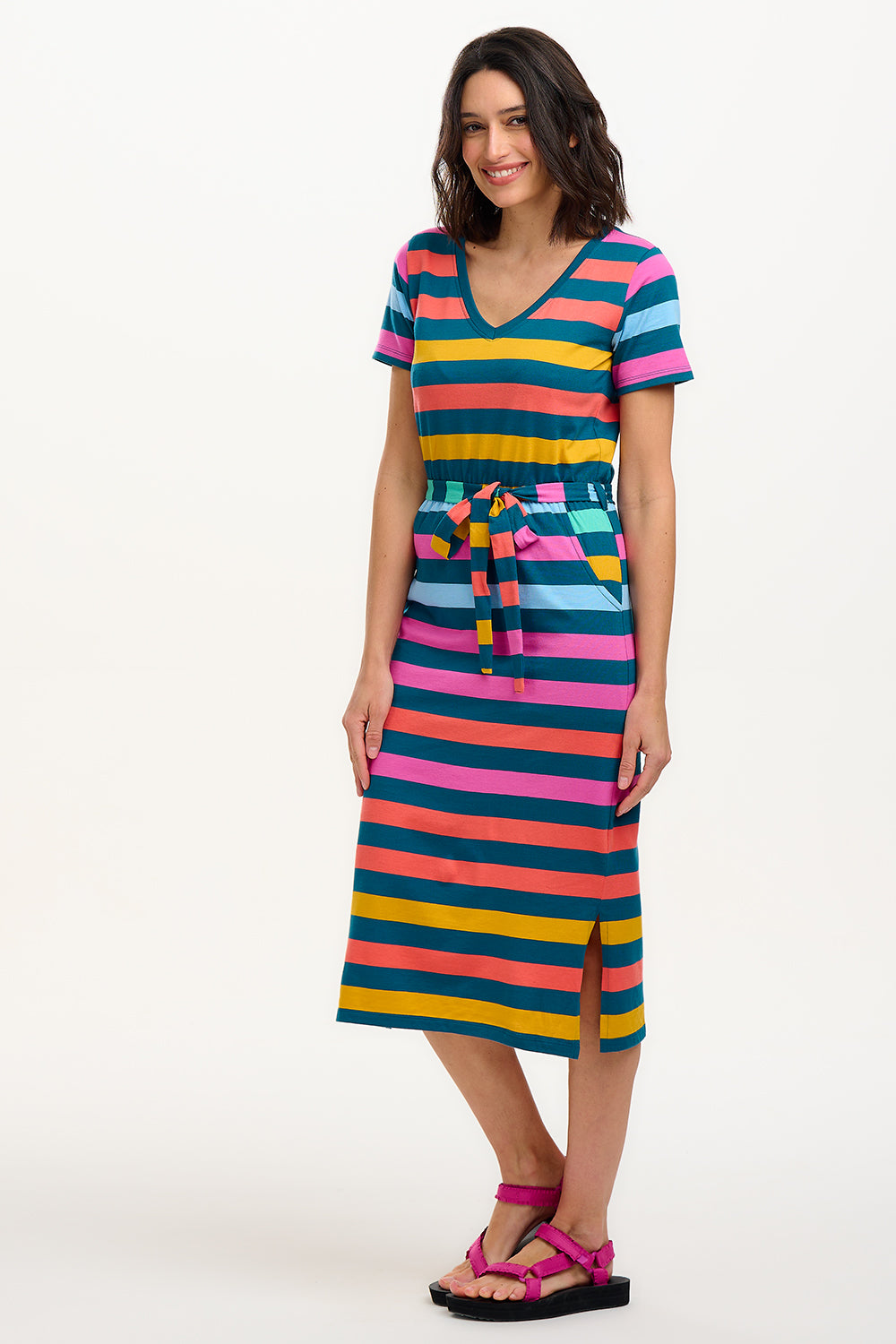 A model wearing a midi-length V-neck dress with stripes in green and other colors, featuring a matching tie belt.