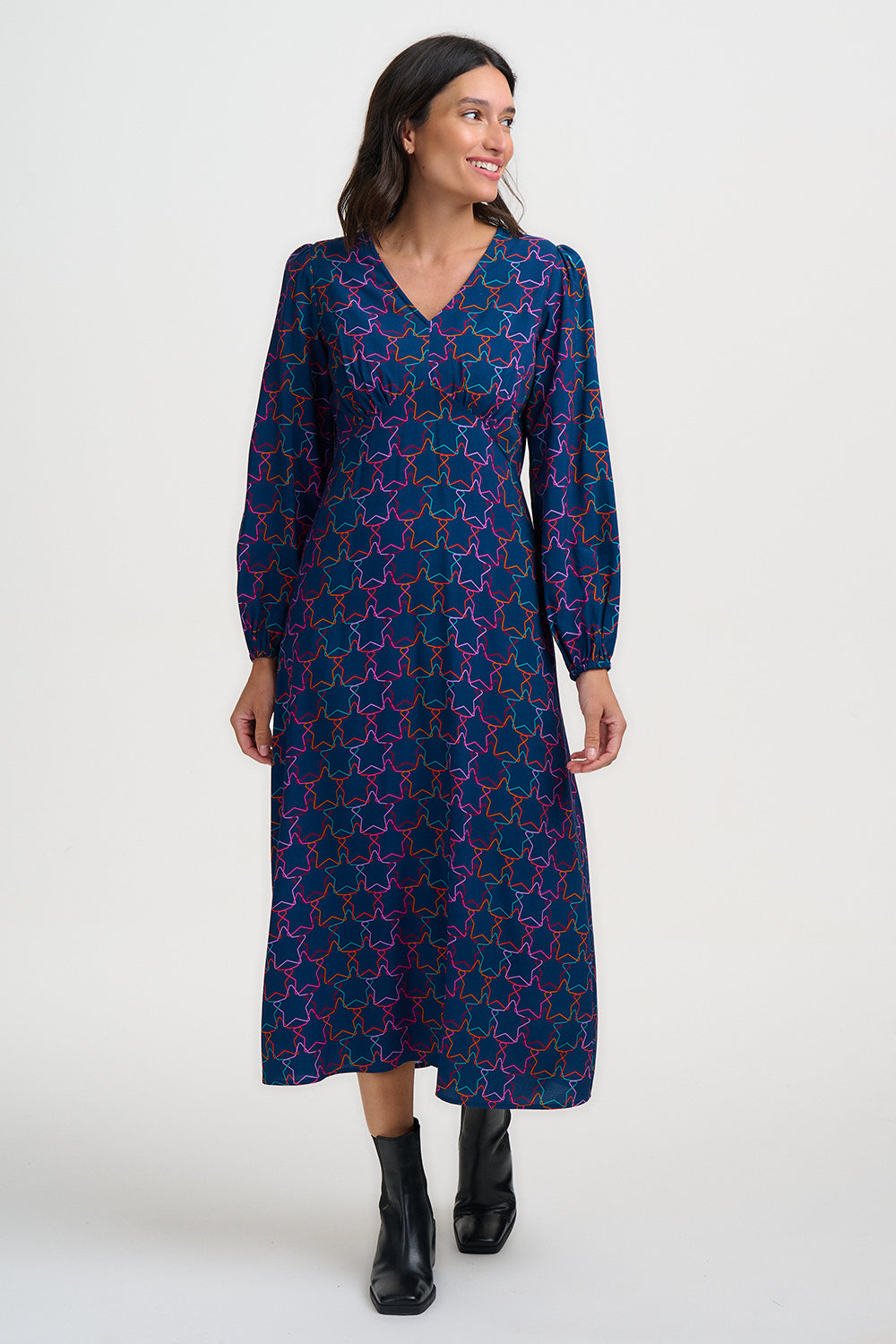 Woman wearing a blue patterned dress on a white background