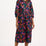 Woman wearing a colorful floral dress on a white background