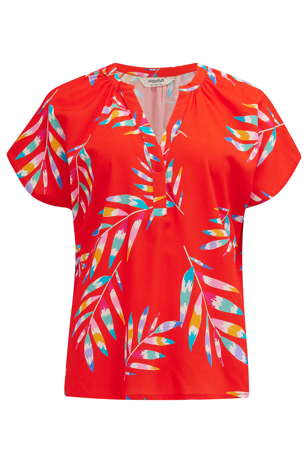 A red blouse with a rainbow frond pattern, short sleeves, and a round neckline.