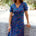 Woman wearing a colorful dress with a white background