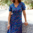 Woman wearing a colorful dress with a white background