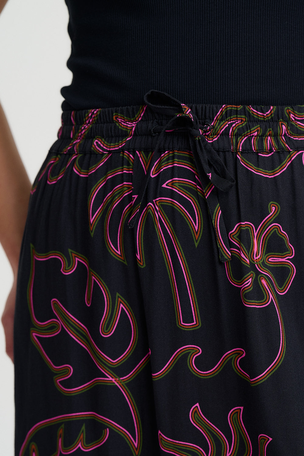 Black skirt with colorful floral patterns on a white background