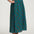 Person wearing a green patterned skirt on a white background