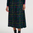 Person wearing a plaid skirt with colorful patterns on a white background