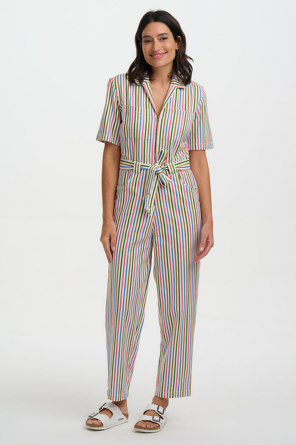 Woman wearing a colorful striped jumpsuit on a white background