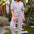 Woman wearing a colorful striped jumpsuit on a white background