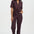 Woman wearing a patterned jumpsuit on a white background