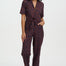 Woman wearing a patterned jumpsuit on a white background