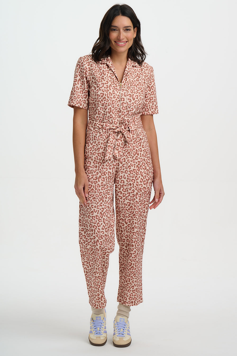 Woman wearing a patterned jumpsuit on a white background