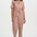 Woman wearing a patterned jumpsuit on a white background