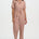 Woman wearing a patterned jumpsuit on a white background