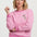 Woman wearing a pink sweatshirt with a floral design on a white background