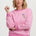 Woman wearing a pink sweatshirt with a floral design on a white background