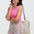 Woman holding a colorful striped bag against a white background