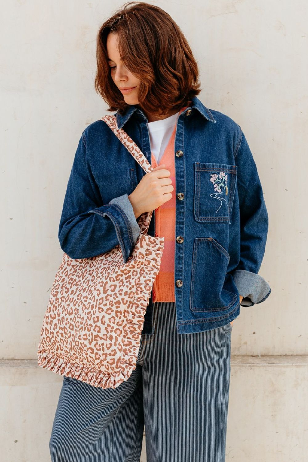 Woman wearing a pink leopard print bag