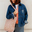 Woman wearing a pink leopard print bag