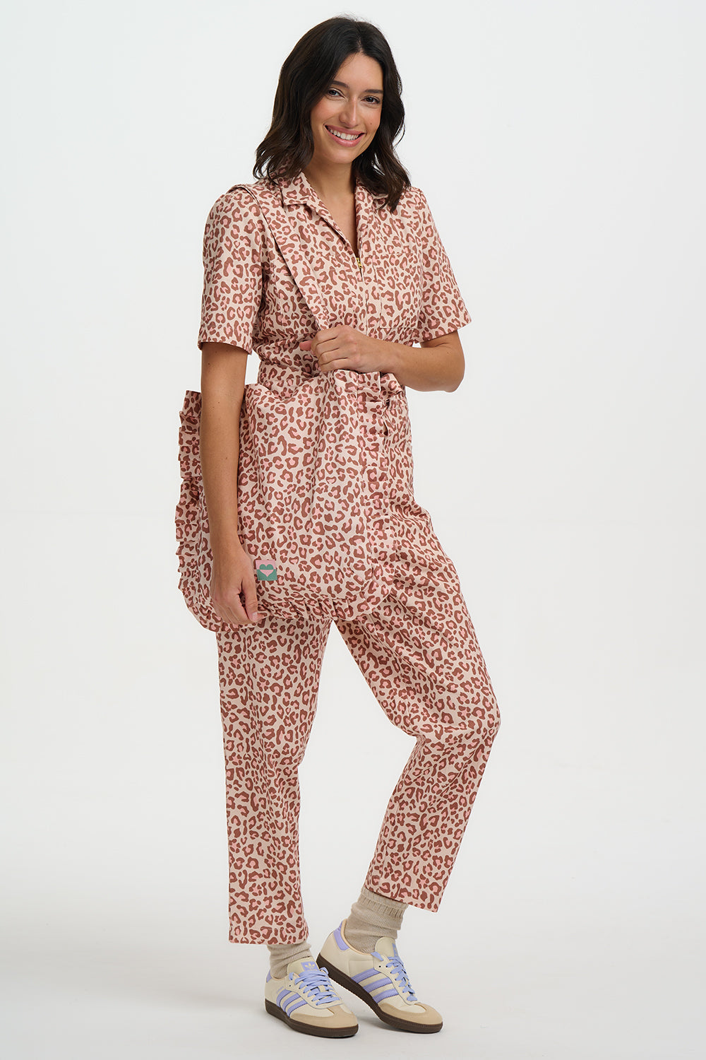 Woman wearing a pink leopard print outfit on a white background