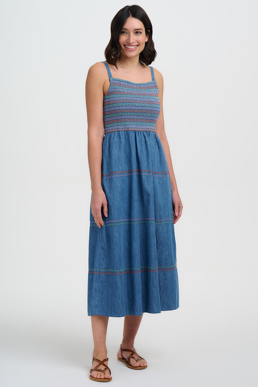 Woman wearing a blue patterned dress on a white background