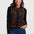 Woman wearing a black cardigan with a tiger stripe pattern on a white background