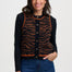 Woman wearing a black cardigan with a tiger stripe pattern on a white background
