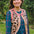 Sugarhill Brighton model wearing a leopard print cardigan over a plaid dress outdoors