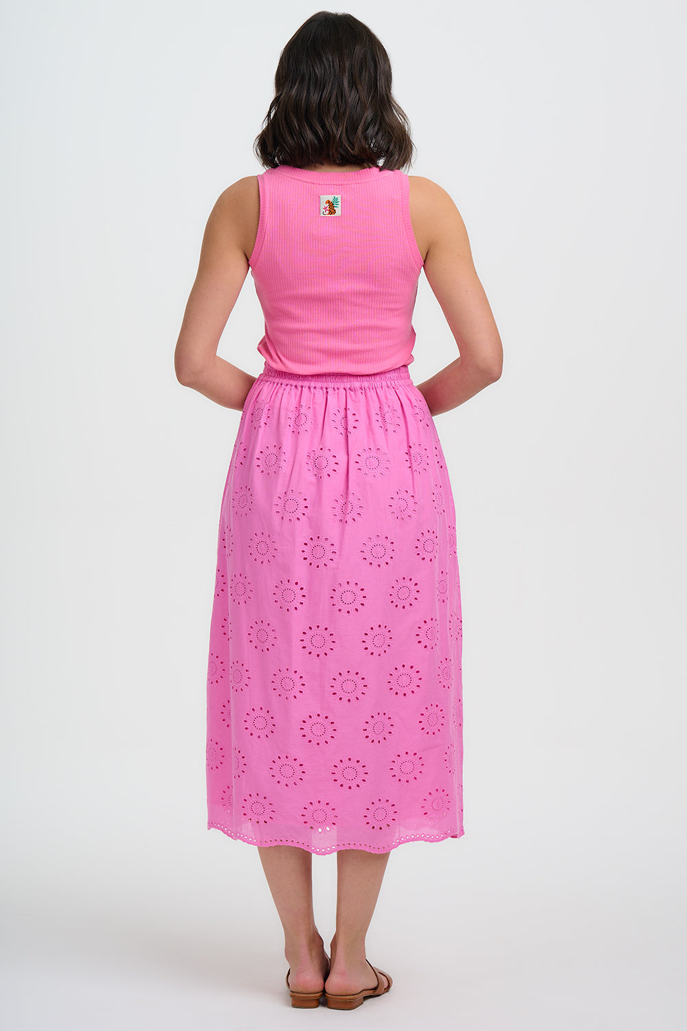 Woman wearing a pink dress with a white background