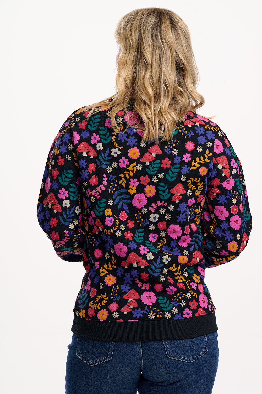Person wearing a colorful floral-patterned jacket on a white background