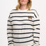 A female model wearing an off-white and black striped Noah sweatshirt with leopard embroidery on the chest.