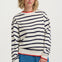Woman wearing a striped sweater and blue jeans on a white background