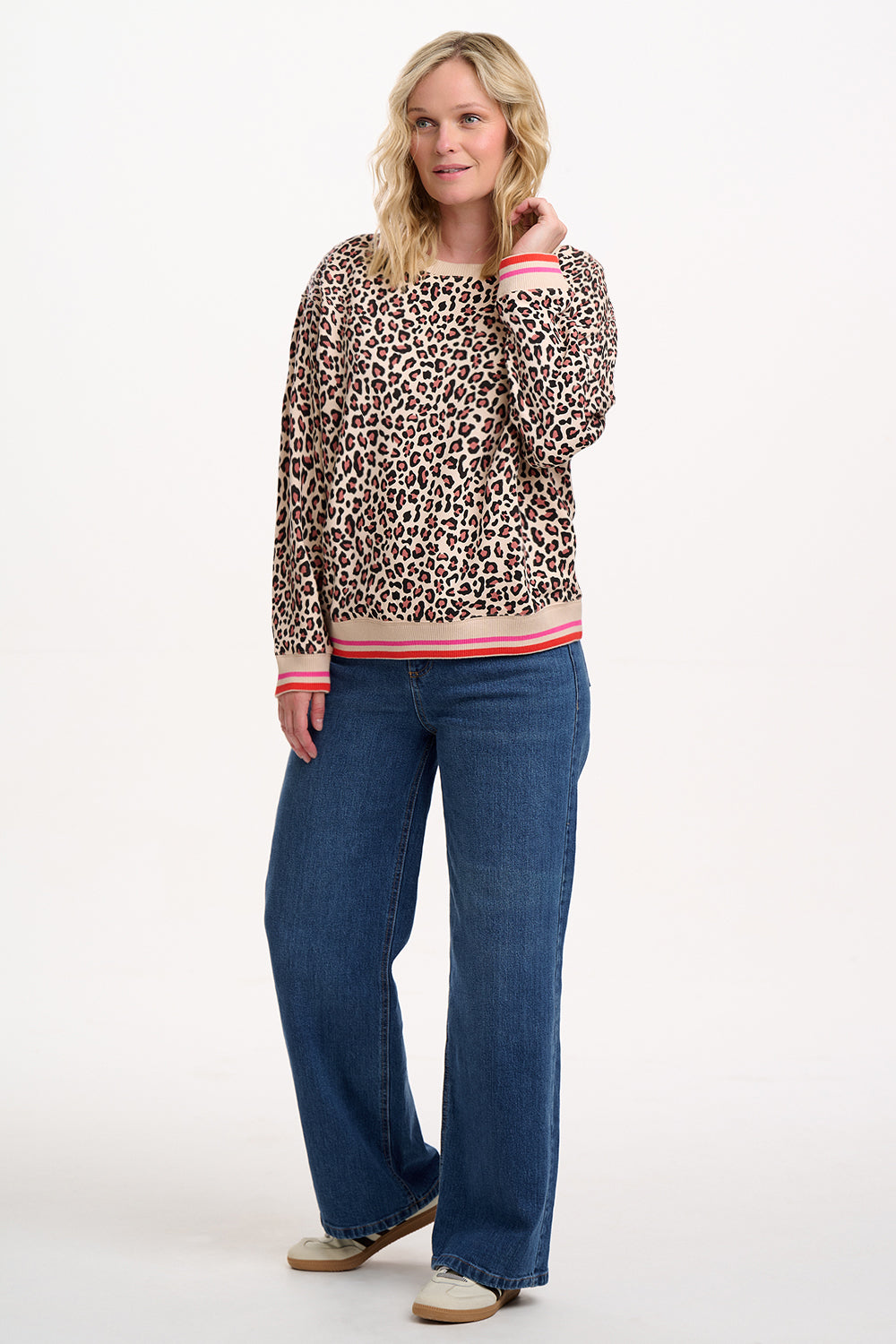 Leopard print sweatshirt with pink and red trim on a white background