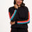 Woman wearing a black outfit with colorful stripes on a white background