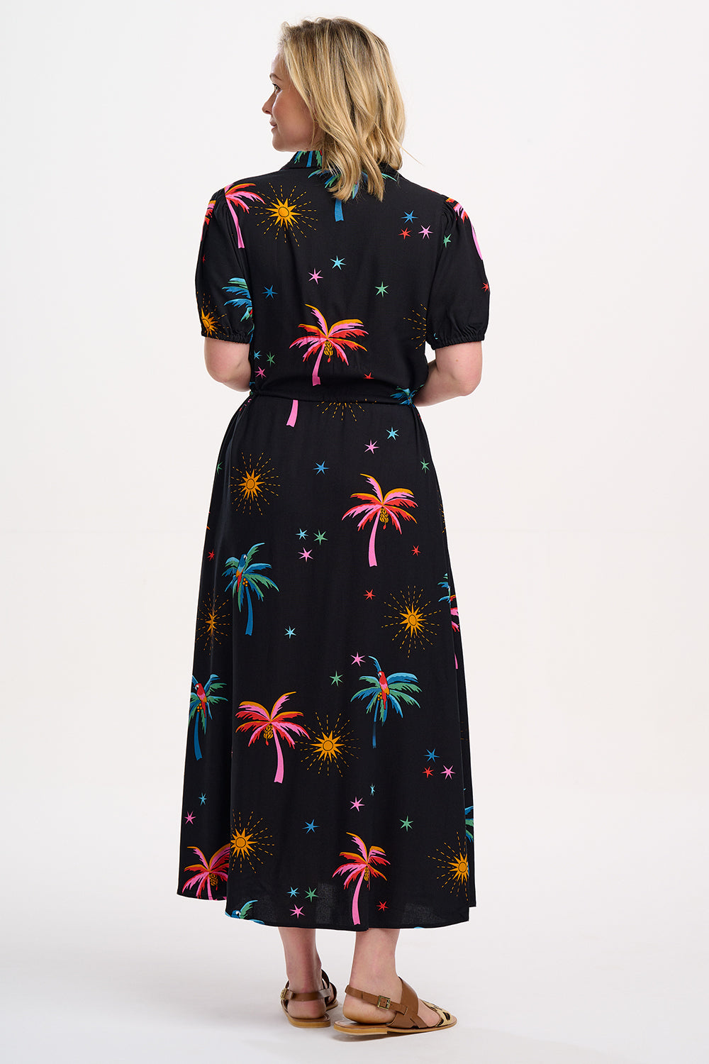 A black maxi shirt dress with a colorful floral pattern featuring palm trees and sunshade motifs.